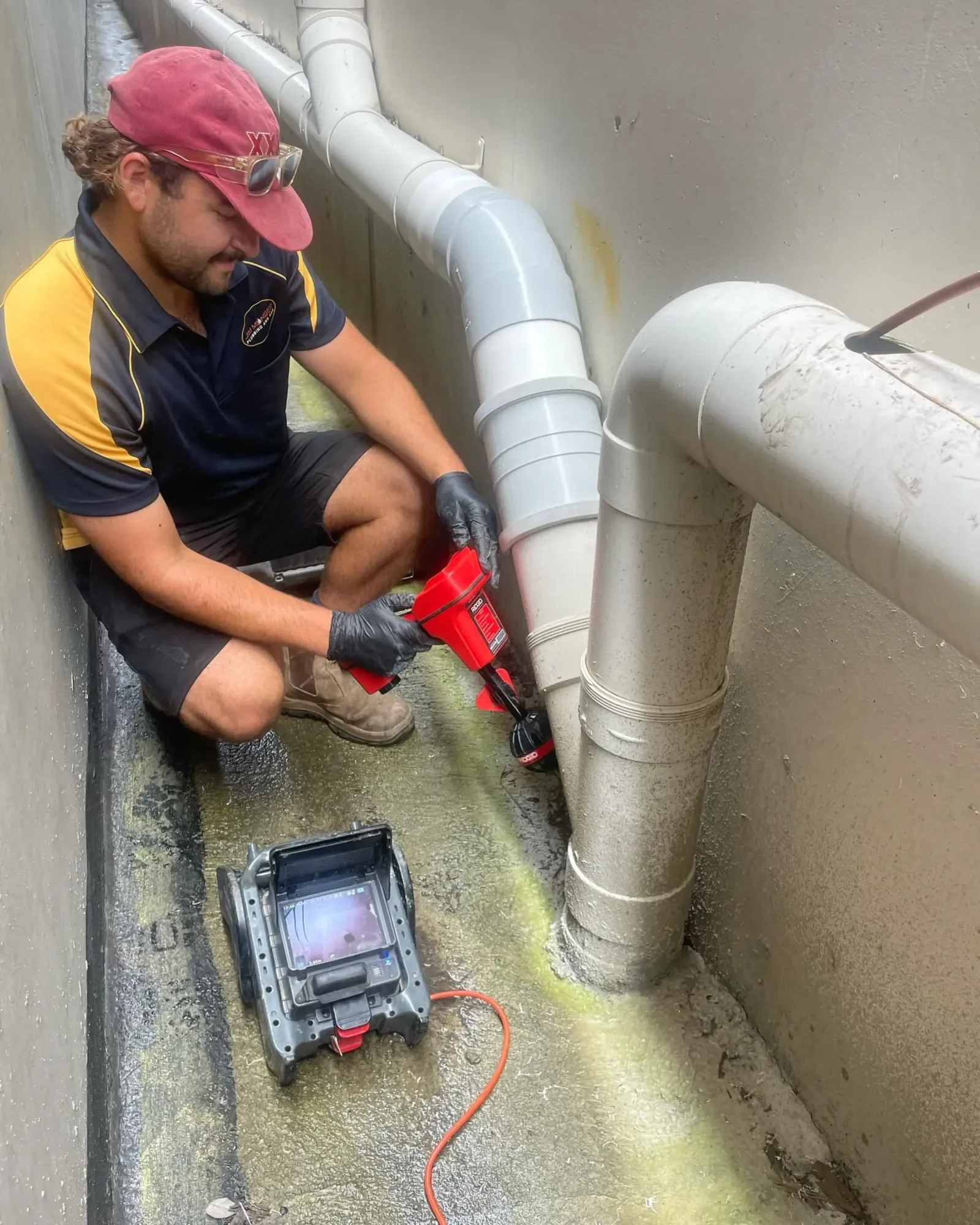 Plumber inspecting a drain line with a camera