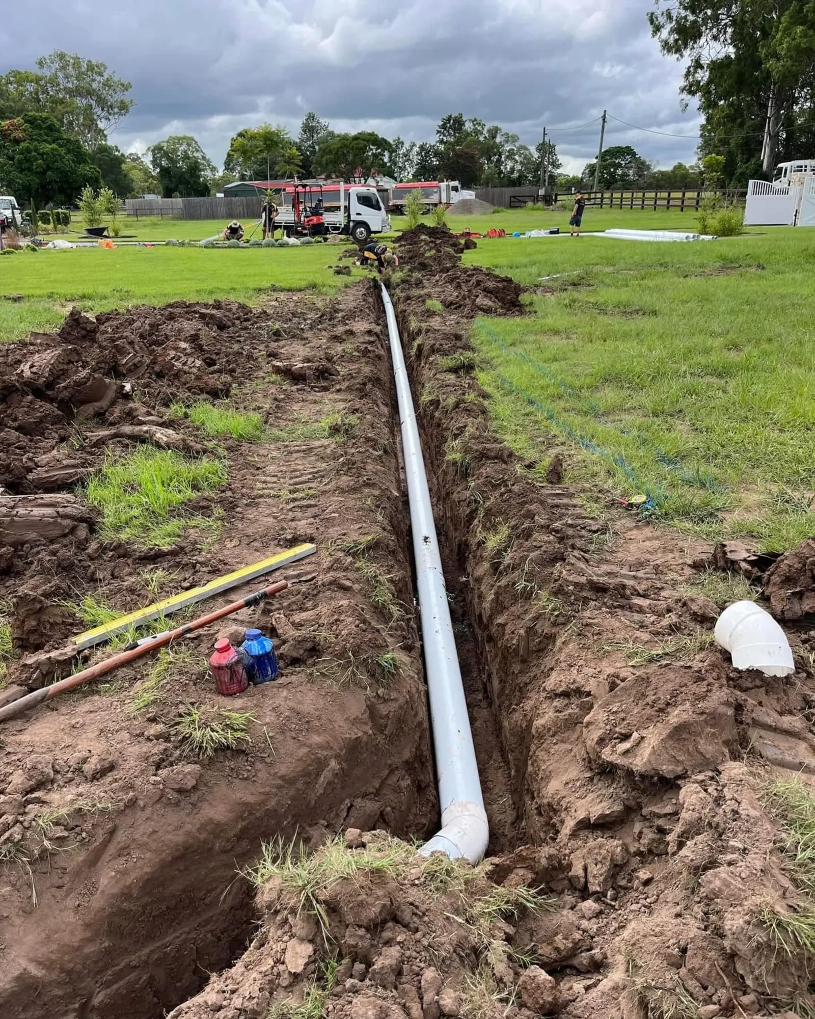Long trench with new pipe running across a property