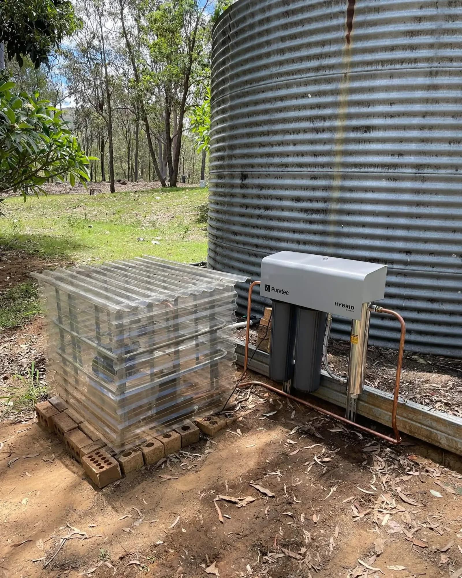 Rainwater tank pump installed beside a large tank