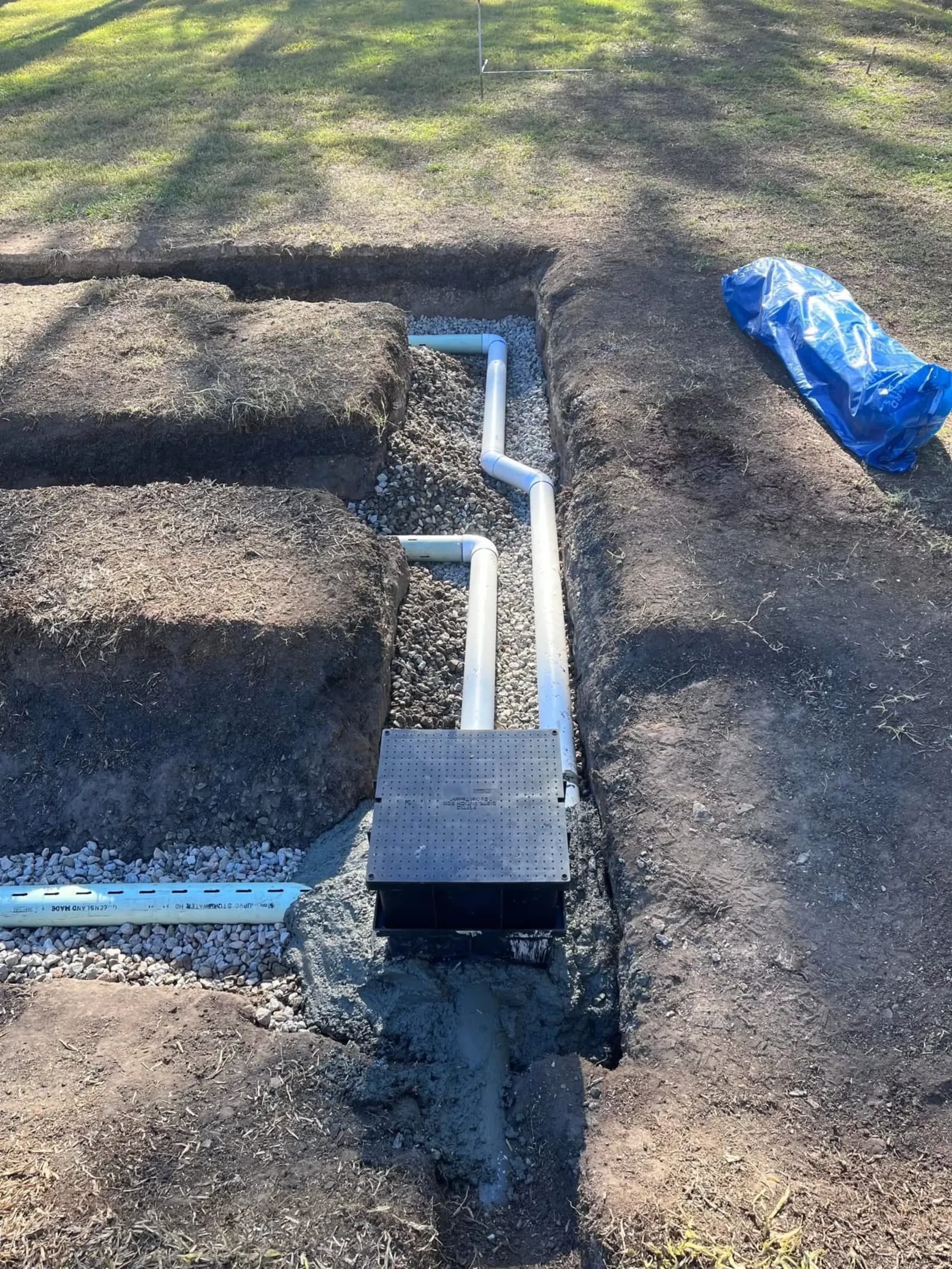 Stormwater pit and drain pipe in a trench