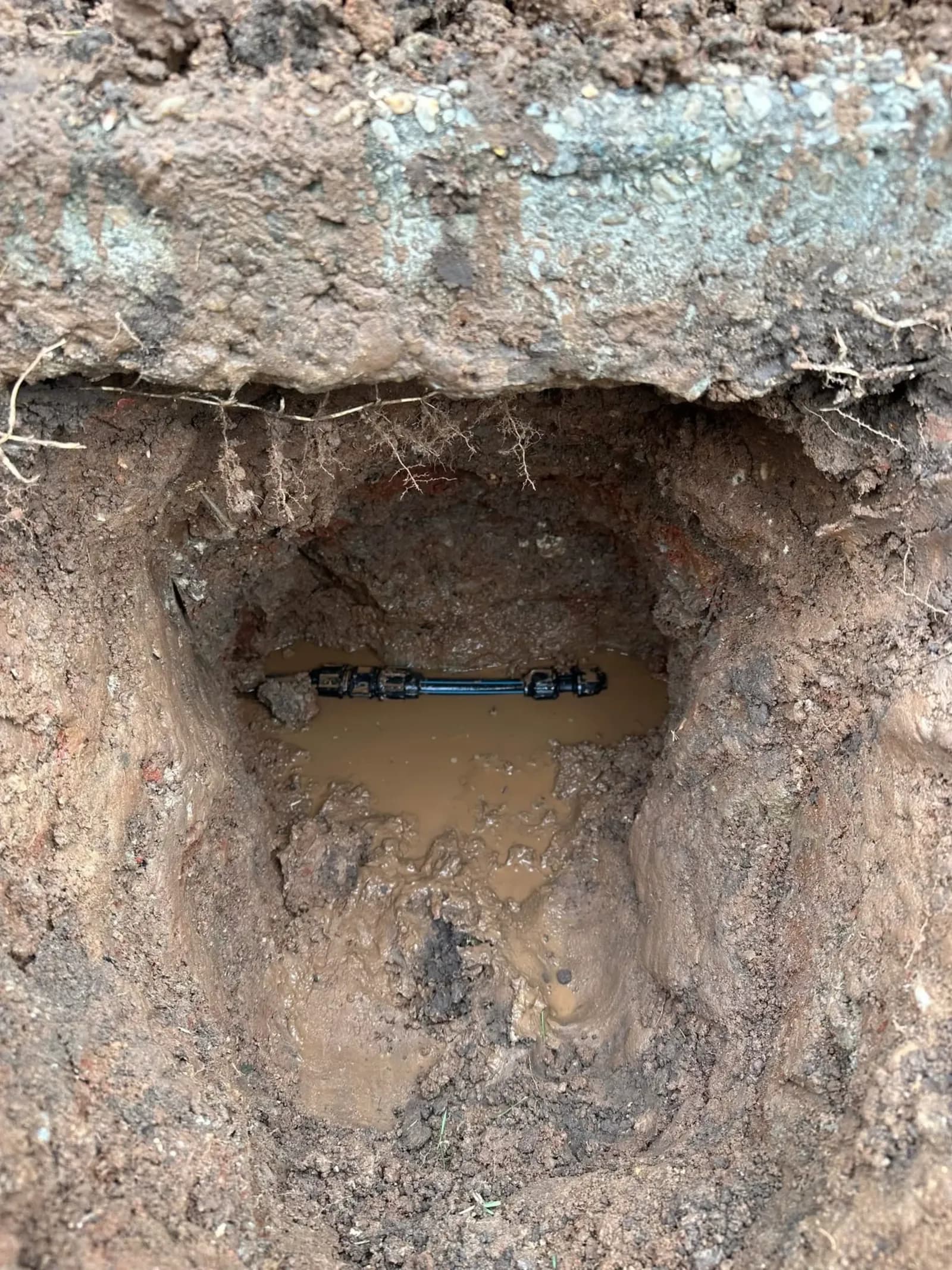 Leaking water pipe in a flooded hole