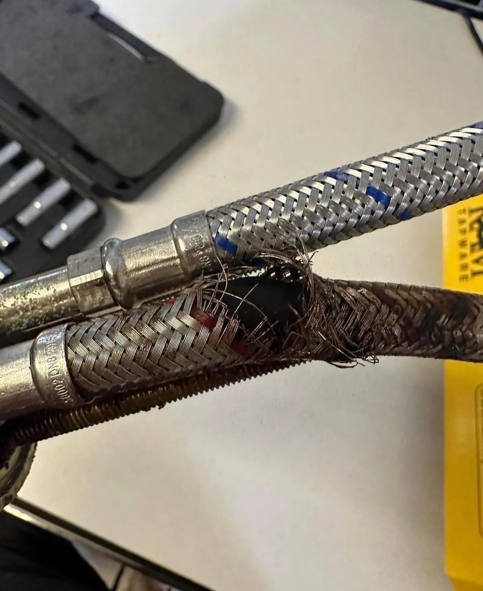 Burst braided flexible hose that has split open