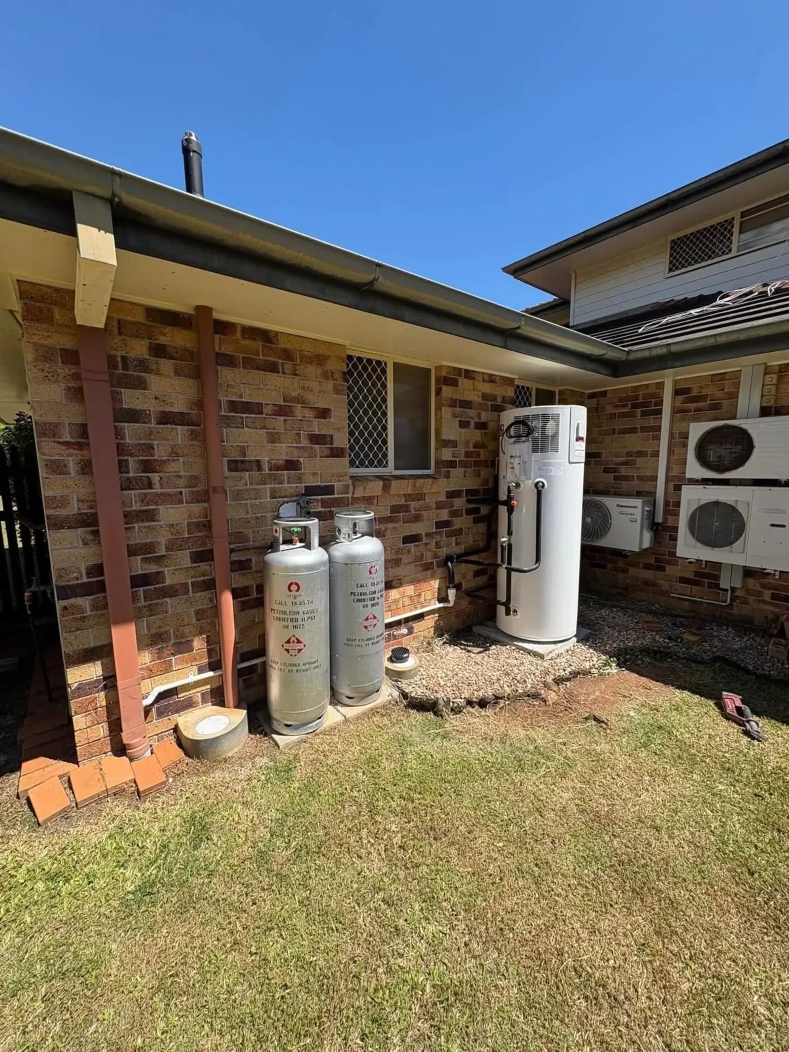 LPG gas bottles connected beside a house
