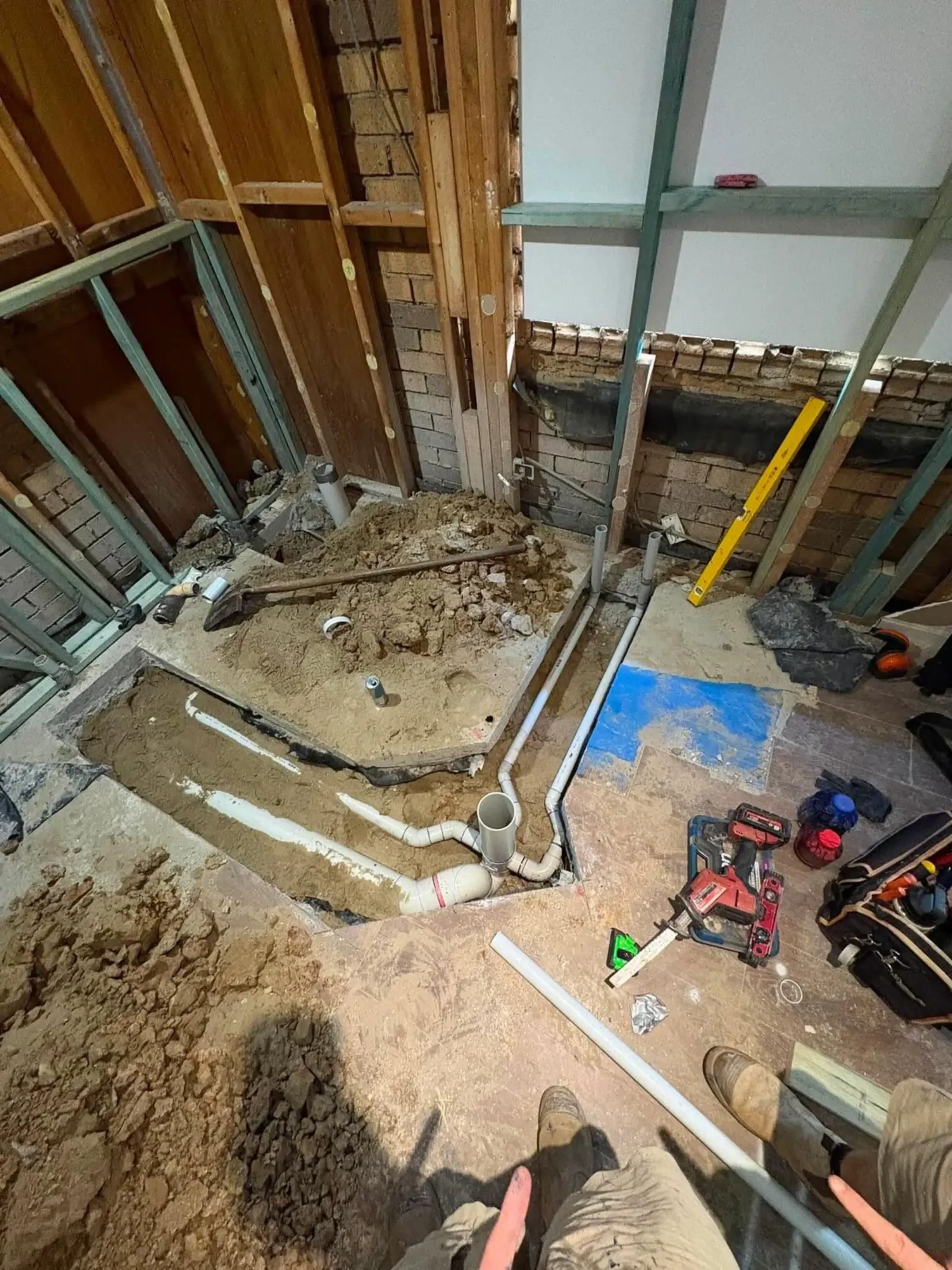 Floor dug up to reach and repair pipes during a renovation