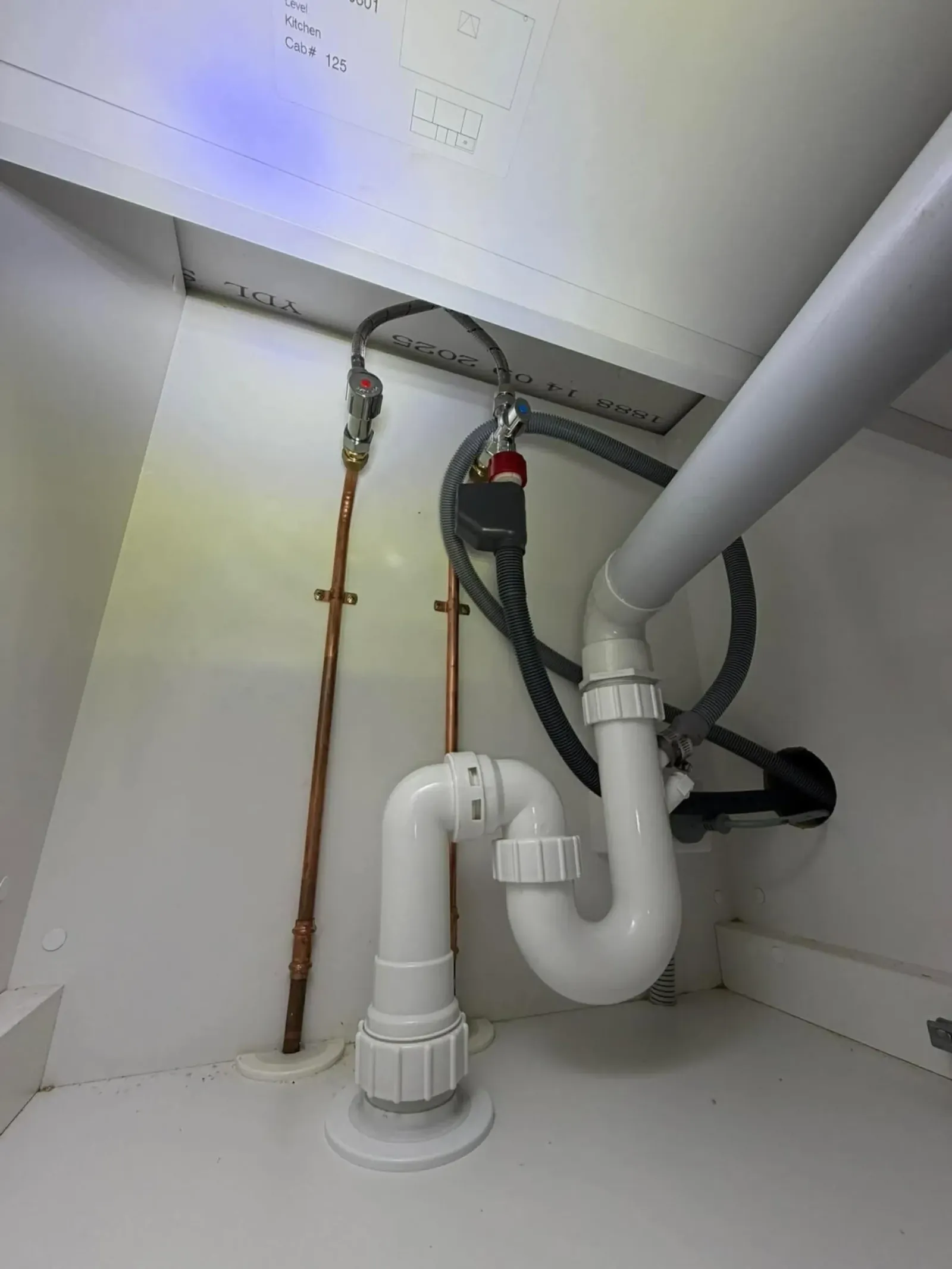 Sink waste trap and drain pipe under a basin