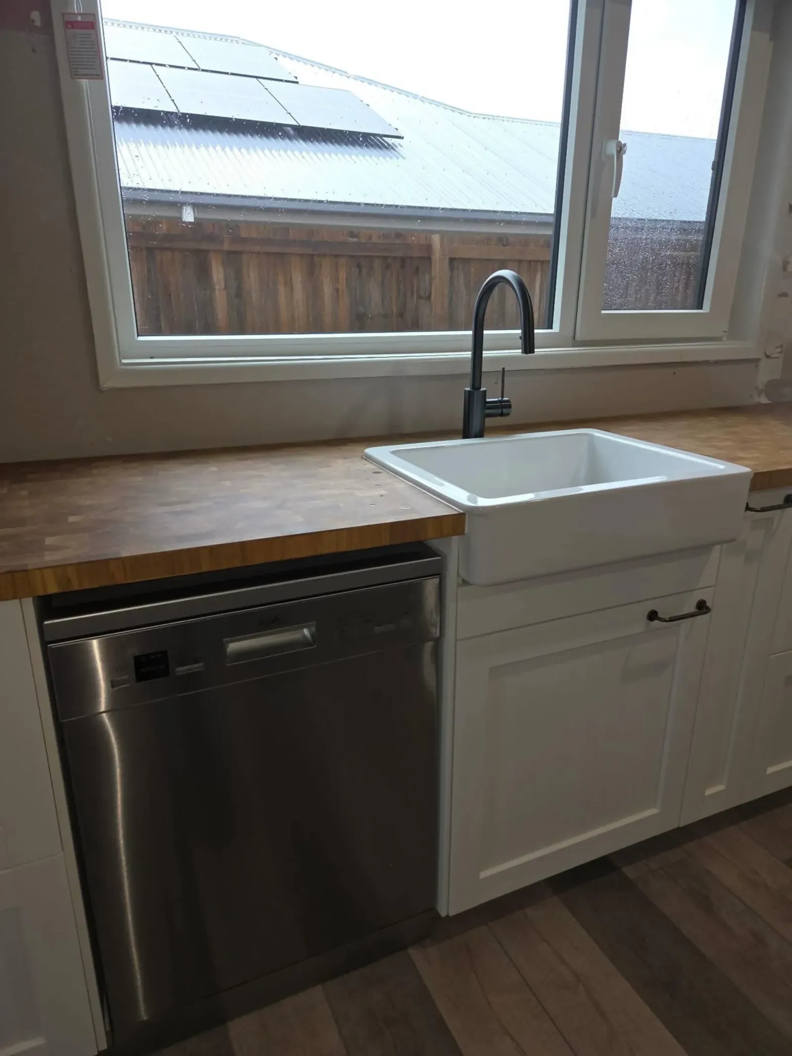 Kitchen with a newly plumbed dishwasher and sink