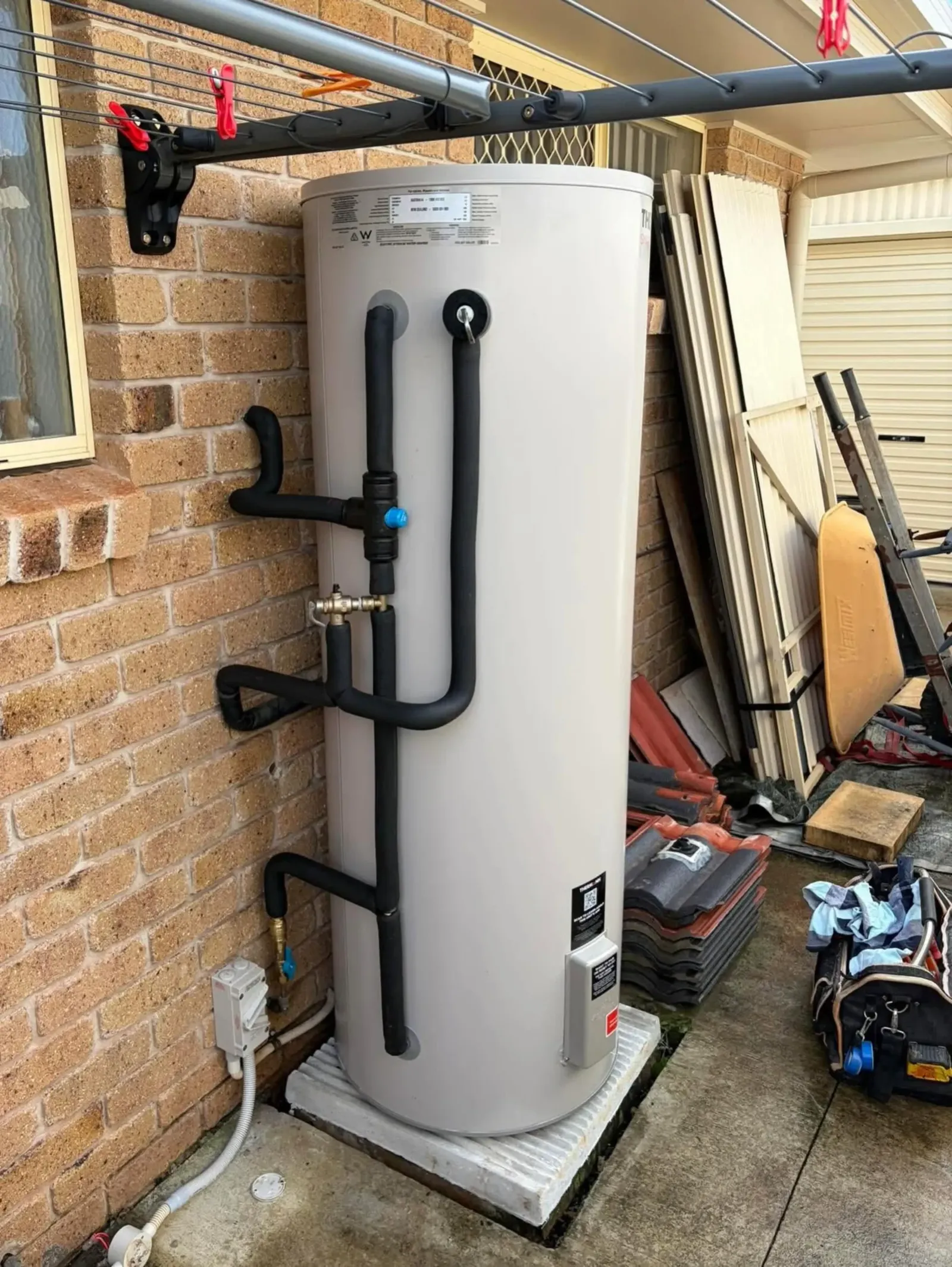 New hot water storage tank installed on a concrete base
