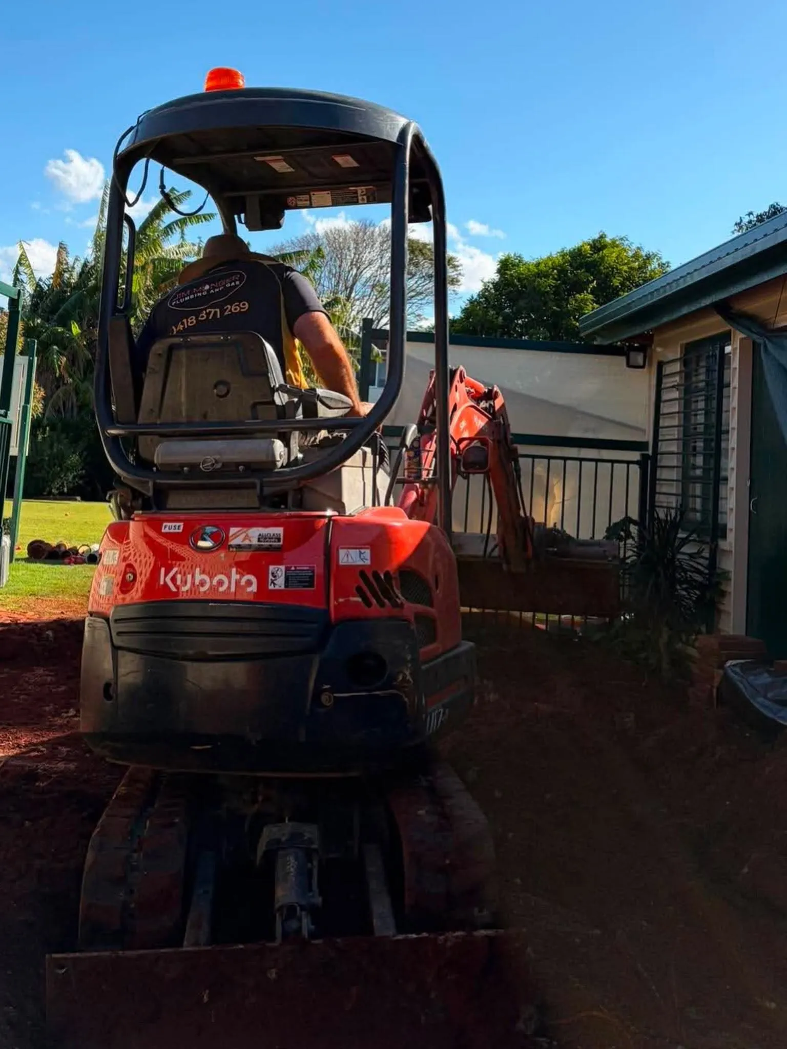 Excavator on site for demolition plumbing work
