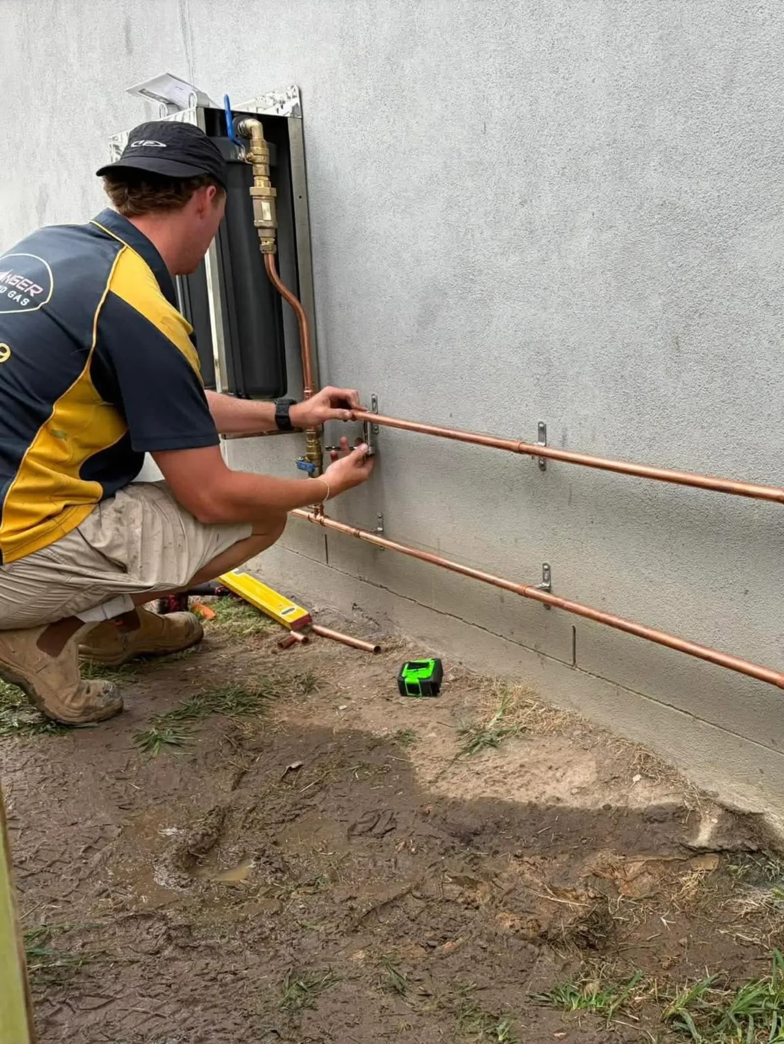 New copper pipe being fitted to a wall